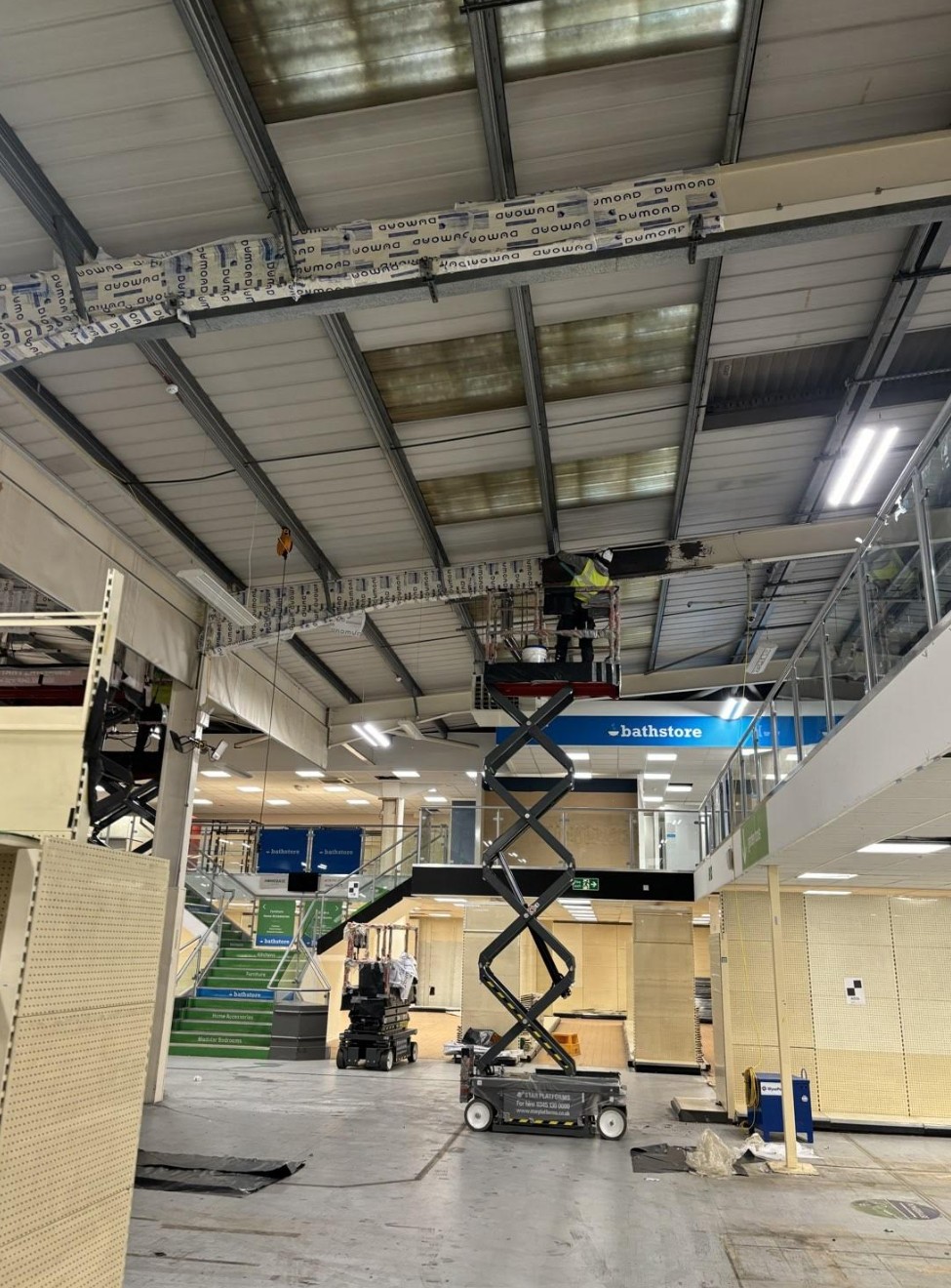 Fire Fort applying overhead intumescent coating to structural steel during a Surrey fire protection project